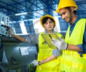 Diligenciamento de Inspeções e Equipamentos 2 Dois inspetores industriais analisando equipamentos em um ambiente fabril.